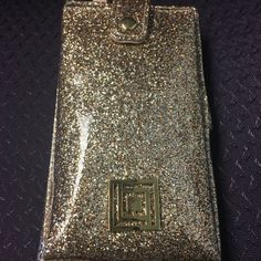 a purse that is sitting on top of a purple cloth with a gold square in the center