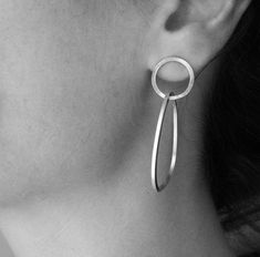 "These double hoops earrings are such a statement, yet they stands out for their simplicity. Made in sterling silver, the earrings are very comfortable to wear. The small hoop is a circle, whereas the bigger hoop has a pebble like shape, which gives to the piece a more natural look. Great accessory for your minimalist look, and amazing gift idea! Measures/Details Small hoop diameter: 0.6\" (1.5 cm) Big hoop measures: 1.6\" by 1.2\"(4 cm by 3 cm) All my pieces are carefully handmade. Irregulariti Pebble Earrings, Modern Silver Earrings, Handmade Silver Jewellery, Double Hoop Earrings, Accesories Jewelry, Metal Clay Jewelry, Big Hoop Earrings, Silver Earrings Handmade, Hoops Earrings