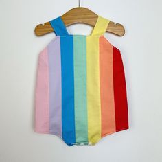 Baby retro rainbow romper. Poppers for easy changing, relaxed fit, plenty of room for nappies (cloth or disposable). Fully lined with light soft cotton. Seamless insides making them comfortable against babies skin. Rainbow design made up of carefully selected colours of 100% premium quality cotton. Adjustable length straps. Spring Multicolor Cotton Onesie, Playful Multicolor Bubble Romper For Spring, Fun Cotton Bubble Romper For Playtime, Multicolor Bubble Romper For Summer Playtime, Multicolor Cotton Bubble Romper For Playtime, Playful Multicolor Bubble Romper For Summer, Multicolor Jumpsuits And Rompers For Summer Playwear, Playful Multicolor Bubble Romper For Playtime, Spring Multicolor Onesie For Playtime