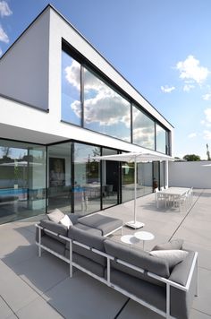 an outdoor living area with couches and tables