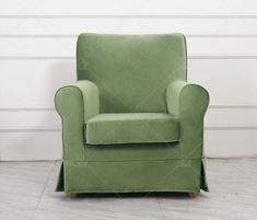 a green chair sitting in front of a white wall