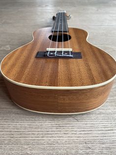 an ukulele is laying on the floor and ready to be played