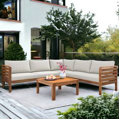 an outdoor living area with couches and coffee table