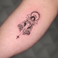 a tattoo on the arm of a woman with an angel and stars above her head