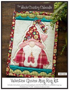 a patchwork christmas decoration with a santa clause on it's chest and the words, valentine gnome mug rug kit