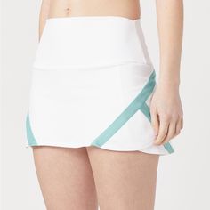 Elevate Your Game Style With The Clean Lines Of The Kswiss Women's Reflex Skirt. It Has A Wide Elastic Waistband, A Built-In Shortie With Side Ball Pockets, Contrast Insert Accents At The Sides, Moisture Wicking Comfort And A Kswiss Logo At Back Waist. Content: 92% Polyester, 8% Lycra Built-In Shortie With Side Pockets Moisture Wicking Colors: White Sporty Fitted Mini Skirt, Green Casual Tennis Skirt, Casual Green Tennis Skirt, White Fitted Skort With Built-in Shorts, Green Athleisure Tennis Skirt, Sporty Tennis Skirt With Lining, Fitted White Tennis Bottoms, Fitted White Bottoms For Tennis, Green Tennis Skort In Athleisure Style