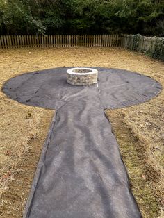 an outdoor fire pit in the middle of a yard