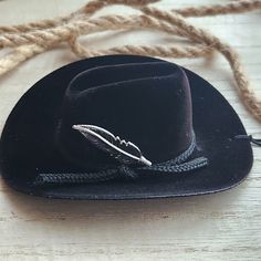 3 inch black flocked mini cowboy hat with silver feather charm on black stretch string. Hang this adorable cowboy hat from your rear-view mirror or in your home for a touch of country charm. String is approximately 6 inches but could be cut for a shorter drop if needed. Makes a great gift. >>S H I P P I N G details<< ✔️Ships in 1-2 days Adjustable Black Mini Hats For Western-themed Events, Black Adjustable Top Hat For Western Theme, Black Mini Hats With Short Brim For Rodeo, Black Mini Hat With Short Brim For Rodeo, Adjustable Black Mini Hat For Rodeo, Adjustable Black Top Hat As A Gift, Adjustable Black Top Hat Gift, Mini Cowboy Hat, Mini Cowboy