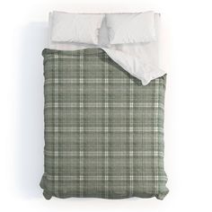 a green and white plaid bed spread with two pillows on top of the pillowcase