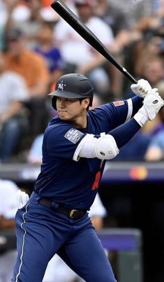 a baseball player holding a bat on top of a field in front of a crowd