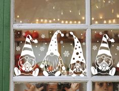 there are three gnomes on the window sill and one is holding his hands up