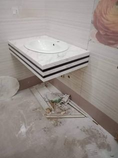 a white sink sitting on top of a counter in a bathroom