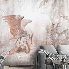 a living room scene with a couch and wallpaper that has an image of birds on it