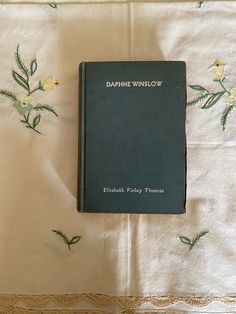 a book sitting on top of a white table cloth