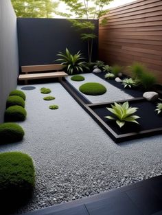 a garden with rocks, grass and plants