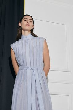 The Luna pleated shirt dress in a beautiful lightweight Cotton |Silk is an elevated, and uniquely designed dress for that special occasion. This fully lined style features a box pleated front and back, with a concealed button front opening, concealed front opening, and modern collar stand. Includes matching sash belt for optional wear.NB: Dress comes fully lined. Model is wearing an un-lined sample.Colour: Ice Blue Fit: Loose fit silhouette.Model is wearing a Size S / AU8 Fabric & Care:Main: Cot Knife Pleated Dress, Classic Essence, Modern Nostalgia, Helmut Lang Dress, Flamboyant Gamine, Open Dress, Pleated Shirt Dress, Knife Pleat, Garment Care Labels