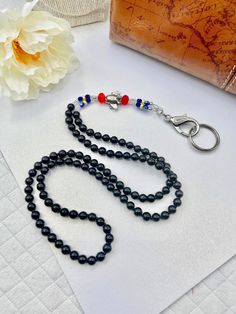 "Short Petite ID Lanyard for women 5\"2\" and under. Perfect for Flight Crew wearing Red, Black, Blue and Yellow uniform pieces. This adorable Airplane lanyard is elegant... and cute!  With the Pewter Airplane bead, surrounded by Black Pearls and glass beading in blue, red, clear and yellow, this Airplane Jewelry ID Lanyard is colorful and ready to fly!  The nape is full of 8mm Black glass pearls, giving a comfortable wear. I've crafted this Jewelry Lanyard a Short Petite 32\" length.  On strong beading wire, a removable hook system (if your hook ever breaks), and a strong hook and key ring, you'll be able to keep all your airline essentials close while staying pretty." Black Lanyard With Key Leash For Personal Use, Adjustable Black Lanyards For Personal Use, Adjustable Black Lanyards For Everyday Use, Adjustable Black Badge Holder With Key Leash, Adjustable Black Lanyards For School, Adjustable Black Lanyard For School, Black Lanyard With Key Leash As Gift, Jewelry Lanyard, Yellow Uniform