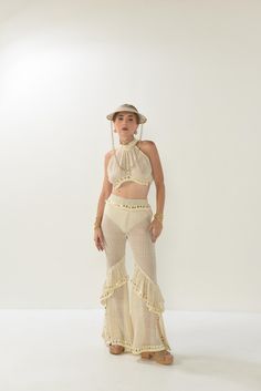 Get into the groove with these handmade crochet pants! Featuring a breathable, lightweight design and fun gold accents, these flared pants are perfect for your next festival or beach day. With their flowy ruffles and boho-chic style, they're designed for movement and freedom. Pair them with a matching crochet top or mix and match with your favorite essentials for a look that's all you Each piece is custom-made to order, ensuring it's crafted specifically for you. While the design is one-of-a-kin Fitted Beach Bottoms With Crochet Trim, Fitted Summer Bottoms For Festival, Fitted Summer Festival Bottoms, Bohemian Bottoms With Crochet Trim For Summer, Bohemian Summer Bottoms With Crochet Trim, Hippie Style Bottoms For Beach Festival, Hippie Stretch Bottoms For Beach, Summer Festival Bottoms With Crochet Trim, Fitted Hippie Bottoms For Vacation