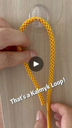 someone is tying a yellow and red rope on a wooden surface with the words that's a kalmyk loop