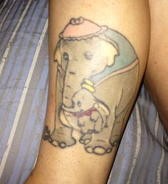 a person with a tattoo on their leg that has an elephant and a dog in it