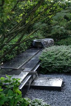 an outdoor garden with rocks and plants