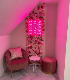 a pink room with a neon sign that says girls's girls on it and a chair in the corner