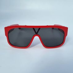 These modern Louis Vuitton 1.1 Millionaire Mask Sunglasses feature a contemporary mask shape with a full lens, a red acetate frame, S-lock hinges with LV initials and a discrete Monogram pattern on the top bar. Model: Z1260W Size: W - Western Material: Acetate Made in: Italy Condition: NEW with original Louis Vuitton box & dust bag, no case. Western Material, Louis Vuitton Box, Mask Sunglasses, Mask Shapes, Bar Model, Monogram Pattern, Bar Top, Hinges, Dust Bag