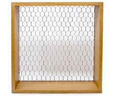 a wooden frame with a chicken wire pattern on the front and sides, hanging from a white wall