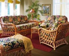 a living room filled with lots of furniture and flowers on the couches next to each other