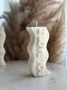 a white candle sitting on top of a table