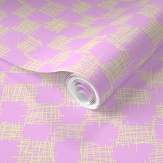 a pink and yellow wallpaper with white lines on it's surface, as well as a roll of tape