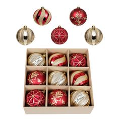 twelve christmas baubles in a box with ornaments on the top one is red and gold