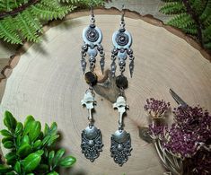 Drilled raccoon vertebrae, tiger's eye beads, metal charms and ear wire attached to metal connectors. Bohemian Bone-colored Nickel-free Earrings, Witchy Earrings, Bone Earrings, Metal Charms, Tiger Eye Beads, Eye Beads, Long Dangle Earrings, Tiger's Eye, Metal Charm