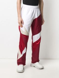 Shop red Reebok colour-block cotton track pants with Express Delivery - Farfetch White Color Block Bottoms For Streetwear, Sporty White Color Block Bottoms, Sporty White Color Block Pants, White Color Block Cotton Pants, White Sportswear Sweatpants With Elastic Panels, White Cotton Color Block Pants, White Sweatpants With Elastic Side Panels, White Gym Bottoms With Side Stripes, White Color Block Sports Bottoms