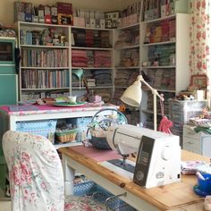 a sewing machine sitting on top of a wooden table in a room filled with books