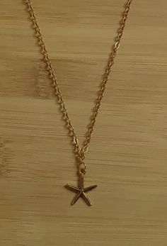 A simple, gold, charm necklace⭐️🐟 Dainty Gold Starfish Charm Necklace, Simple Gold Necklace For Everyday, Gold Charm Necklace With Starfish Charm, Dainty Gold Chain Necklace With Star Charm, Minimalist Gold Necklace With Star Charm, Simple Gold Charm Necklaces For Everyday, Simple Everyday Gold Charm Necklaces, Minimalist Gold Chain Necklace With Charms, Minimalist Gold Jewelry With Starfish Charm