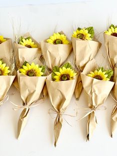 a bunch of sunflowers wrapped in brown paper