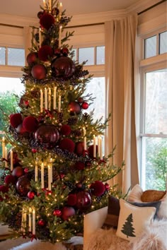 a christmas tree decorated with candles and ornaments