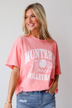 Introducing the Monterey Beach Volleyball Coral Graphic Tee, a must-have addition to your casual wardrobe for those sunny days and laid-back weekends! Crafted from soft, breathable cotton fabric, this tee offers both comfort and style, making it perfect for any outdoor adventure or relaxed outing. Featuring a vibrant coral color, this tee instantly adds a pop of brightness to your ensemble, while the playful graphic print of a beach volleyball scene captures the essence of carefree coastal livin Summer Sports T-shirt With Screen Print, Summer Collegiate Relaxed Fit Tops, Summer Collegiate Style Tops With Relaxed Fit, Collegiate Style Summer Tops With Relaxed Fit, Relaxed Fit Collegiate Summer Tops, Athleisure Short Sleeve Tops For Vacation, Athleisure Short Sleeve Beach Tops, Casual Moisture-wicking Tops For Beach Season, Casual Summer Tops For Sports Events