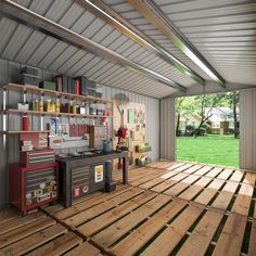 the inside of a garage with wood flooring and shelves on one side, open doors to another