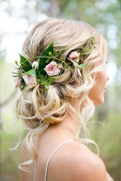 a woman with flowers in her hair wearing a floral headpiece and looking off into the distance