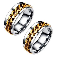 two gold and silver wedding rings with chains on each side, set against a white background