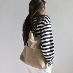 The best tote bags combine casual style with useful functionality in an easy to carry shape. Our canvas hobo bag gets it all just right. Modern and minimalist with lots of pockets in all the right places. Plenty of interior space with just the right amount of slouch so the bag never feels too big.Durably handcrafted with attention to detail in the perfect neutral khaki color that goes with everything.This listing is for the Large size as pictured. Coming soon in Medium and Mini sizes too.Details Canvas Hobo Bag, Best Tote Bags, Lots Of Pockets, Khaki Color, Natural Leather, Have A Great Day, Hobo Bag, Canvas Tote, Snap Closure