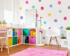 a child's room with colorful storage bins and flowers on the wall