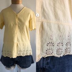 ★ sale! take 30% off 2 items, 40% off 3 items, and 50% off 4 items or more! discount automatically applies at checkout. ★This is a vintage pale yellow cotton top. Blouse is short sleeved with scalloped hem at the sleeves and the waist, buttons down the front, and cut out and sequin details on the bottom.era: 1990slabel size: S [please check measurements]fits like: small/mediummeasurements:bust: 38"hem: 38"length: 24"material: 100% cottonbrand/maker: Jane Ashleycondition: excellent vintage condit Vintage Cotton V-neck Blouse, Retro Cream Top With Short Sleeves, Retro Cream Tops For Spring, Retro Cream Top For Spring, Vintage Cream Blouse For Summer, Vintage Yellow Tops For Spring, Cottagecore Short Sleeve Tops For Daywear, Cottagecore Short Sleeve Summer Tops, Vintage Cream Short Sleeve Blouse