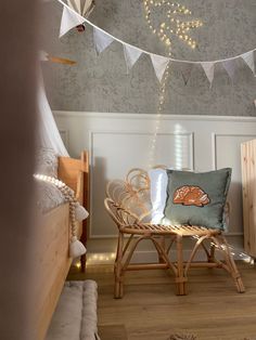 a bed room with a neatly made bed and string lights