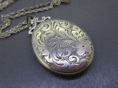 Beautiful antique sterling silver oval locket that comes with a vintage (not original to the locket but still vintage) 18" sterling silver chain.  Locket opens and closes great!  Light age related wear and patina on the locket, some small dings on the back.  Has the original photos inside but no frames/covers.  Visit Ribbons Edge for more great pieces of vintage and antique jewelry!  All items added to your cart at Ribbons Edge will automatically combine shipping. To stay up to date with my newe Ornate Oval Locket Necklace From Vintage Collection, Vintage Silver Oval Pendant Locket Necklace, Vintage Engraved Oval Pendant Locket Necklace, Vintage Engraved Oval Locket Necklace, Antique Etched Oval Locket Necklace, Antique Silver Sterling Silver Vintage Locket Necklace, Vintage Etched Oval Pendant Locket Necklace, Antique Silver Necklace With Vintage Charm, Antique Silver Oval Locket Necklace