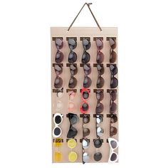 an eyeglass display hanging on a wall with sunglasses in it's trays