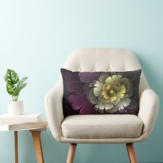 a chair with a pillow on it next to a potted plant