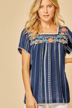 A beautiful top with summer-to-fall versatility. Navy Stripe Embroidered top with round Neckline Neckline has pom pom detail Flowy Fit & Non Sheer Rayon Spring Short Sleeve Tops With Contrast Embroidery, Spring Tops With Contrast Embroidery And Short Sleeves, Short Sleeve Tops With Contrast Embroidery For Spring, Spring Vacation Embroidered Top With Embroidered Neckline, Spring Vacation Embroidered Neckline Top, Embroidered Hem Top For Summer Vacation, Spring Embroidered Top With Contrast Embroidery, Summer Tops With Contrast Embroidery, Bohemian Summer Tops With Embroidered Hem